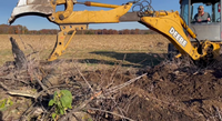 Cleaning Up a Burn Pile with Our New Backhoe Thumb Attachment