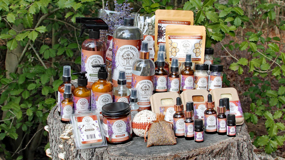 Collection of natural products on a wooden surface with greenery in the background
