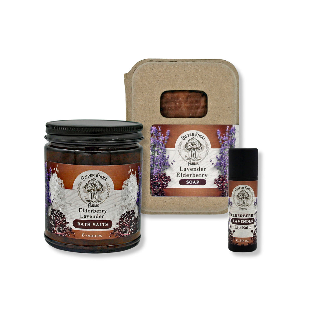 Set of lavender and elderberry themed products including a bath salts, soap, and lip balm on a white background.