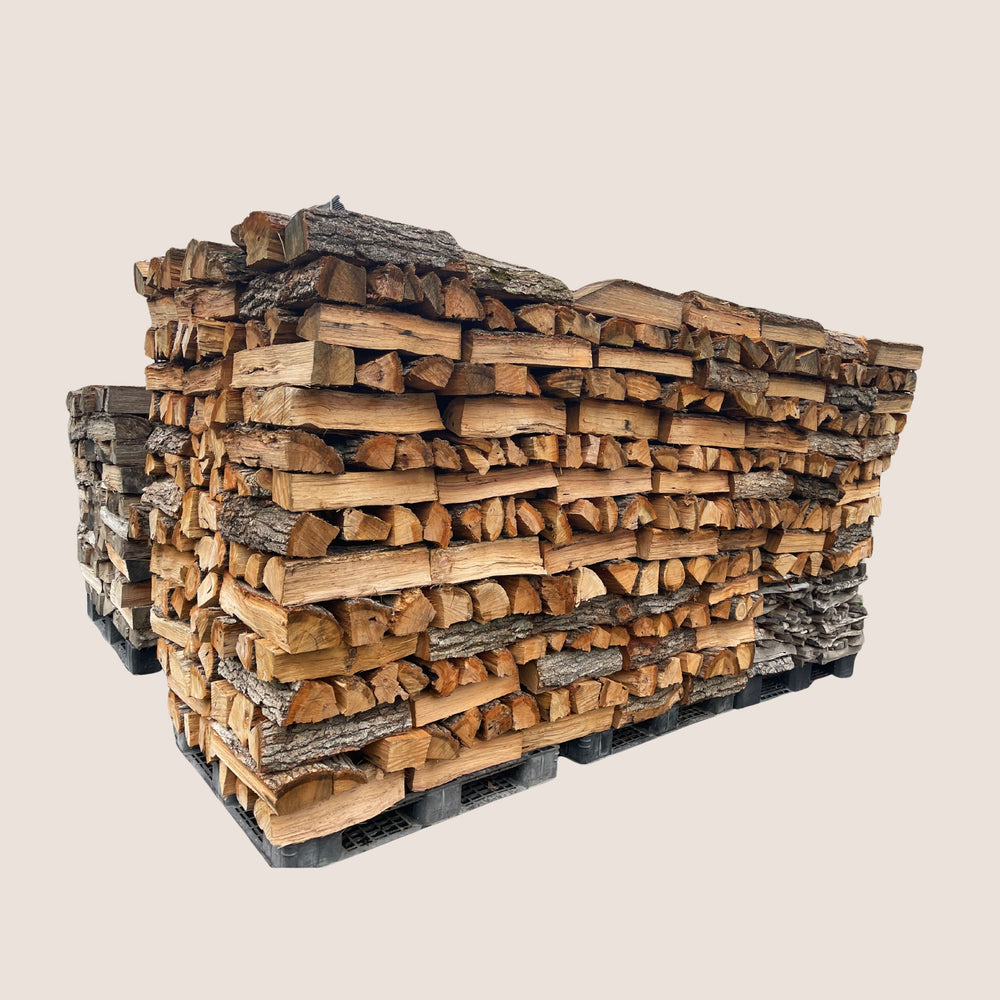 Stack of firewood on a pallet with a beige background