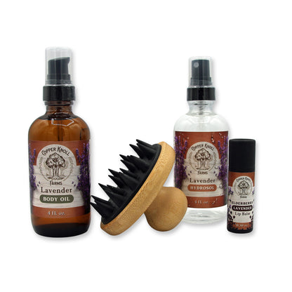 Set of Copper Kettle Farms lavender products including body oil, hydrosol, and lip balm on a white background.